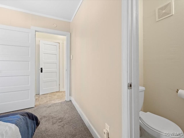 carpeted bedroom with baseboards, visible vents, and crown molding