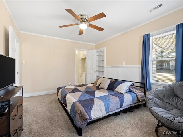 bedroom with baseboards, visible vents, a ceiling fan, ornamental molding, and carpet flooring