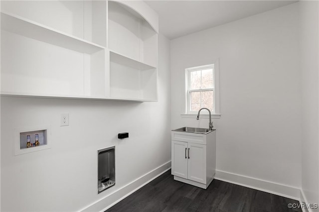 washroom featuring washer hookup, dark wood-style flooring, cabinet space, a sink, and baseboards