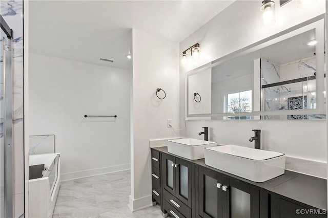 full bath featuring marble finish floor, a shower with shower door, a sink, and visible vents