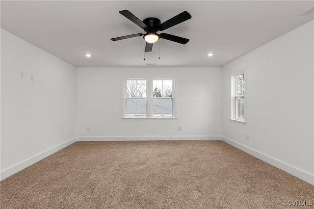 unfurnished room featuring light carpet, plenty of natural light, baseboards, and recessed lighting