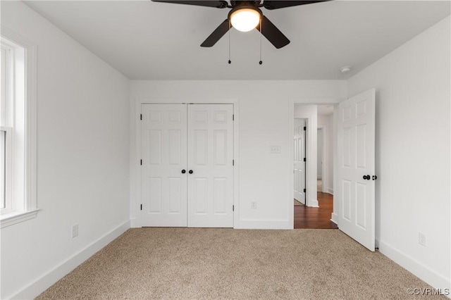 unfurnished bedroom featuring a ceiling fan, carpet, baseboards, and a closet