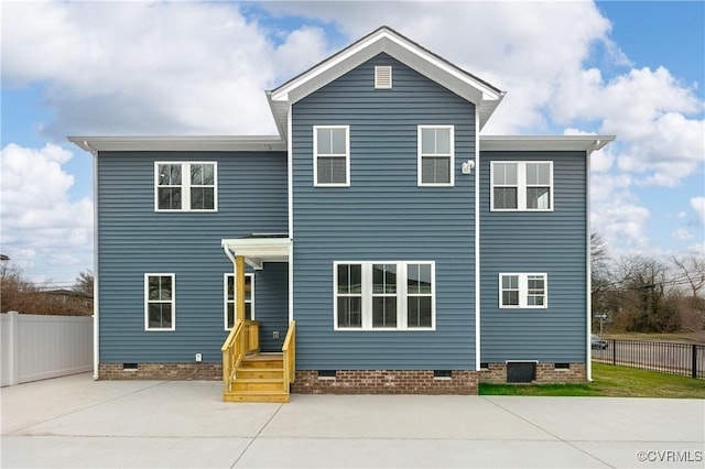 traditional home featuring crawl space and fence