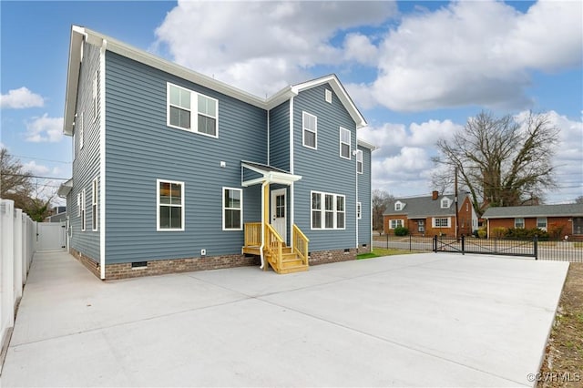 view of front of property with crawl space, a gate, and fence