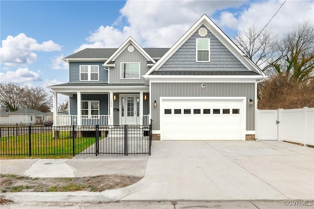 view of front of property featuring a fenced front yard, a porch, concrete driveway, board and batten siding, and a gate