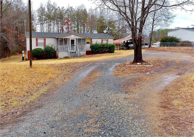 manufactured / mobile home featuring a porch and driveway