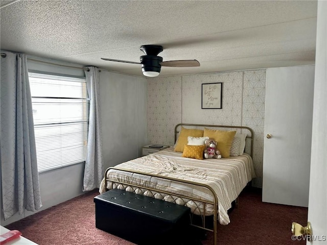 bedroom with carpet floors, ceiling fan, and a textured ceiling