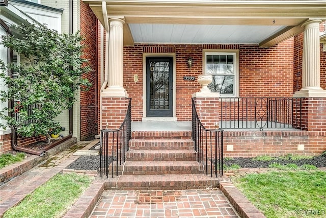 property entrance featuring brick siding