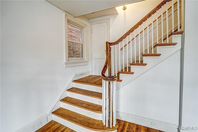 stairs featuring baseboards and wood finished floors