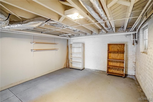 unfinished basement featuring brick wall