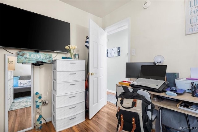 home office featuring baseboards and wood finished floors