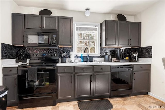 kitchen with baseboards, decorative backsplash, light countertops, black appliances, and a sink