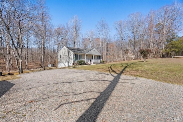 view of front of house featuring driveway, a front lawn, and a porch