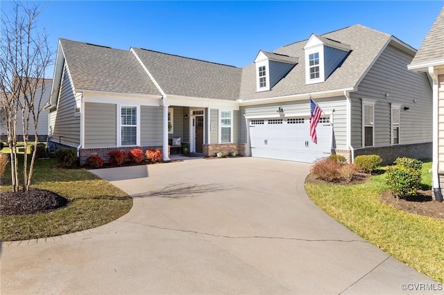 view of front of property featuring a shingled roof, concrete driveway, brick siding, and an attached garage