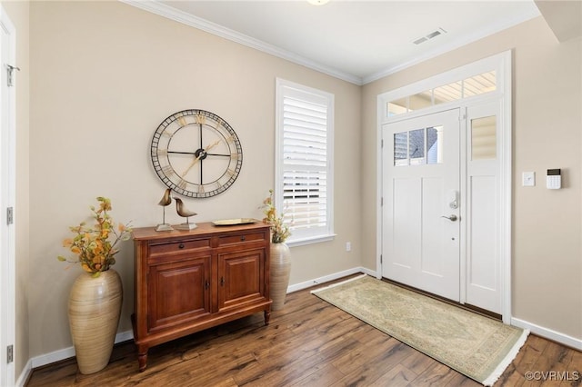 entryway featuring ornamental molding, visible vents, baseboards, and wood finished floors