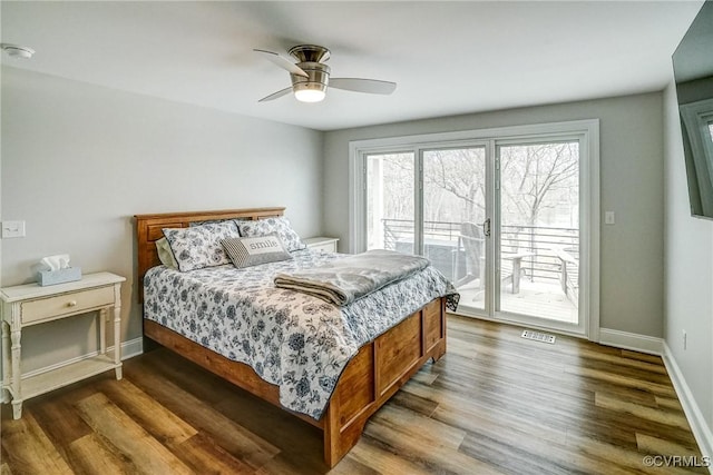 bedroom featuring ceiling fan, wood finished floors, visible vents, baseboards, and access to outside