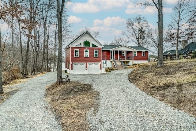 view of front facade featuring gravel driveway and an attached garage