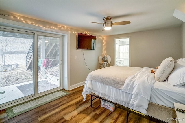 bedroom with access to outside, multiple windows, wood finished floors, and baseboards