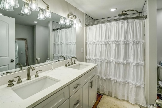 full bath featuring a shower with curtain, a sink, and double vanity