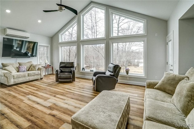 living area with baseboards, wood finished floors, a wall mounted AC, high vaulted ceiling, and recessed lighting