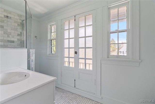 entryway featuring crown molding and a sink