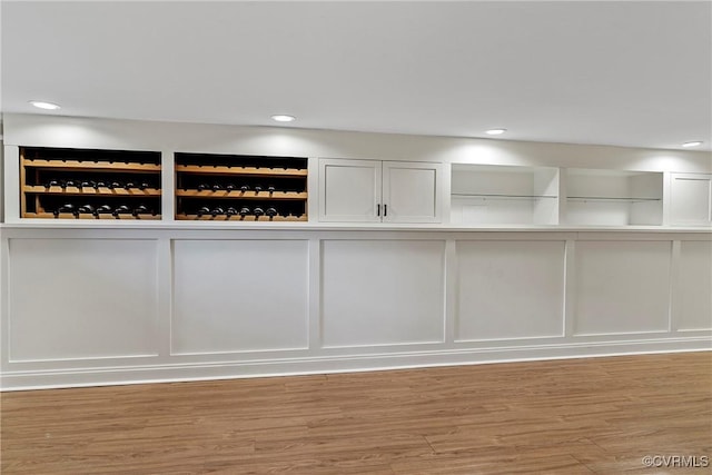 interior space featuring recessed lighting, wood finished floors, and a decorative wall