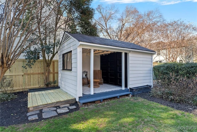 view of outbuilding featuring an outdoor structure and fence