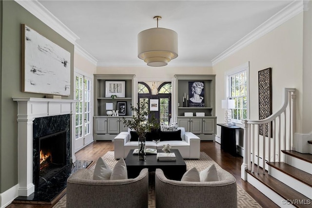 living area with plenty of natural light, stairway, and dark wood-style flooring