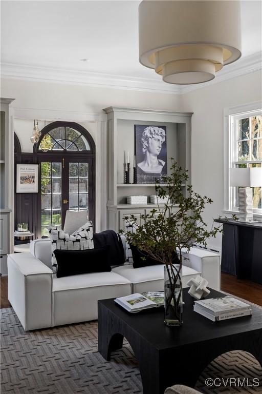 living area featuring french doors and ornamental molding