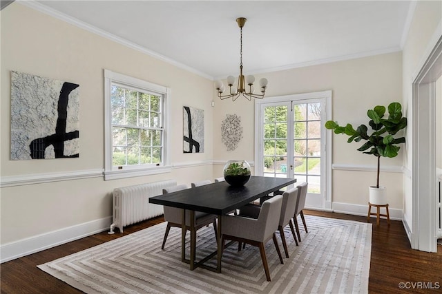 dining space featuring ornamental molding, radiator, and wood finished floors