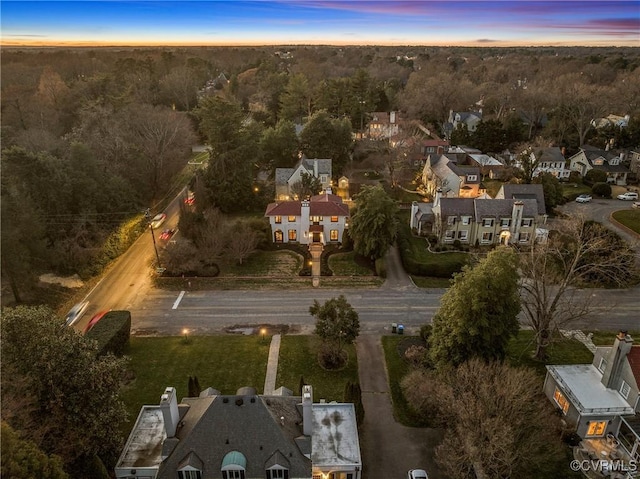 aerial view at dusk featuring a residential view