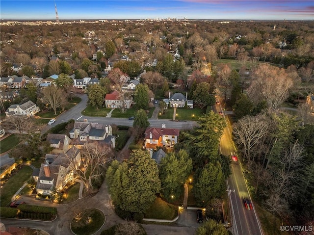 aerial view at dusk featuring a residential view