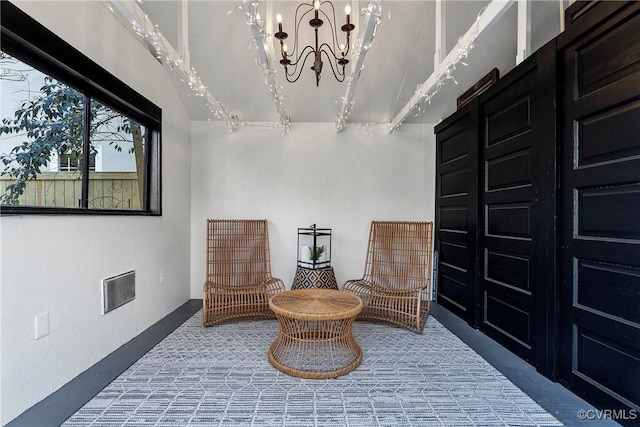 living area with an inviting chandelier