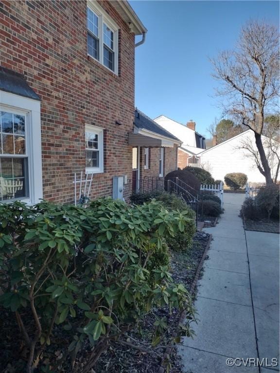 view of side of home with brick siding