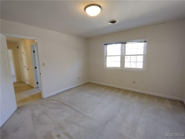 empty room with light carpet, baseboards, and visible vents