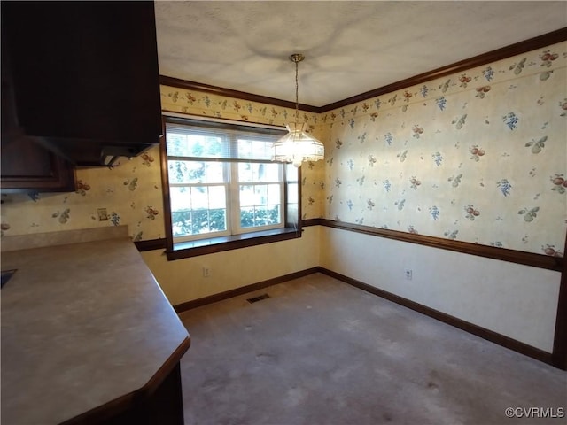 unfurnished dining area with ornamental molding, visible vents, baseboards, and wallpapered walls