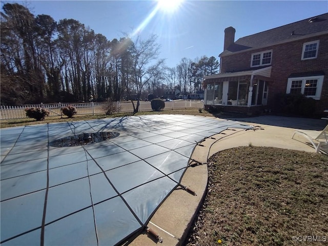 view of pool featuring a fenced in pool, a sunroom, a patio, and fence