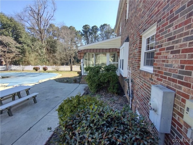 view of patio featuring fence and a fenced in pool