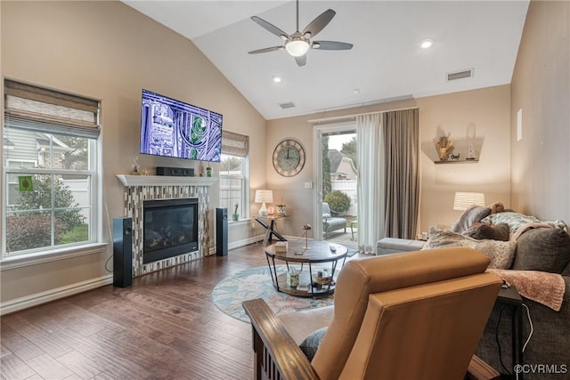 living area featuring visible vents, plenty of natural light, ceiling fan, and wood finished floors