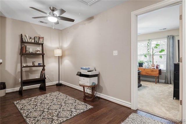 interior space featuring baseboards, attic access, and a ceiling fan