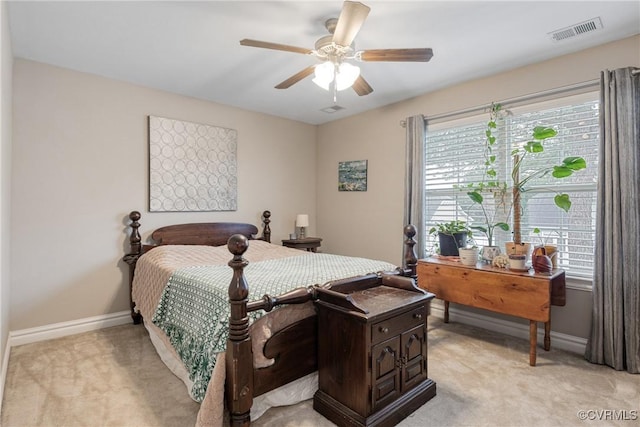 bedroom featuring visible vents, light carpet, multiple windows, and baseboards