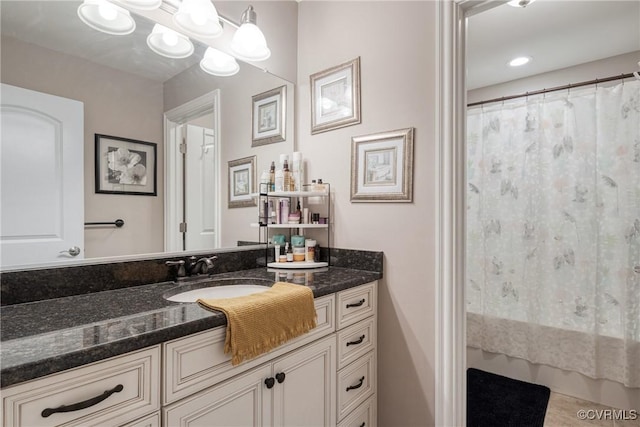 bathroom with curtained shower and vanity