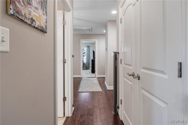 corridor with recessed lighting, dark wood-style floors, and baseboards