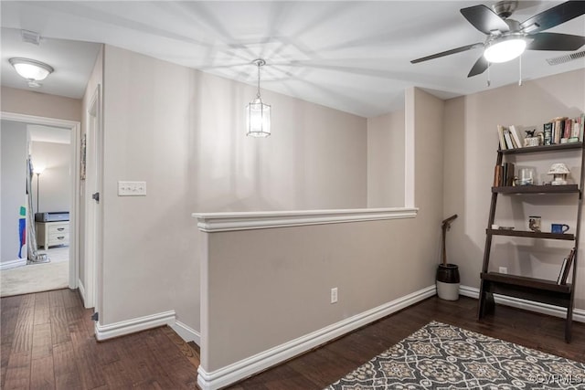 interior space featuring wood finished floors, visible vents, and baseboards