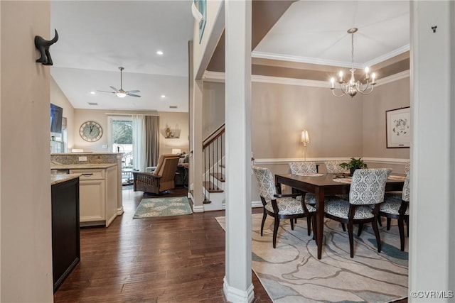 dining room featuring ornamental molding, ceiling fan with notable chandelier, dark wood-style floors, stairway, and lofted ceiling