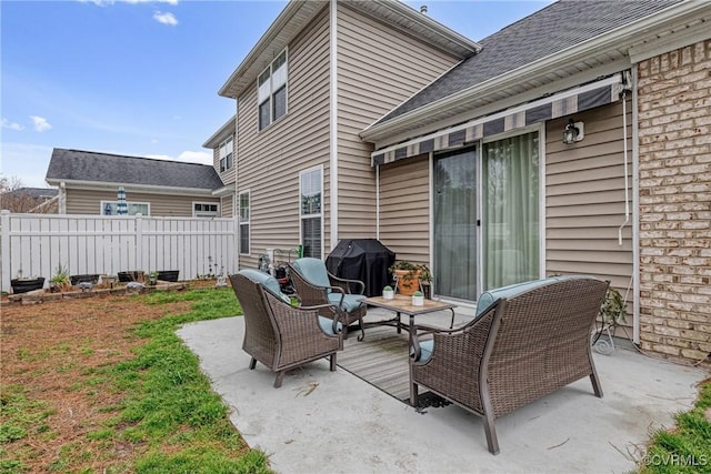 view of patio with fence and a grill