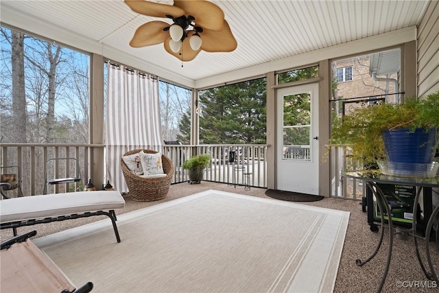 sunroom / solarium featuring ceiling fan