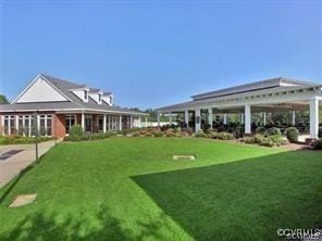 view of property's community with a lawn