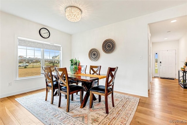 dining space featuring recessed lighting, a notable chandelier, baseboards, and light wood-style floors