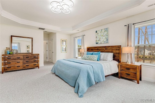 bedroom featuring a raised ceiling, visible vents, and carpet floors